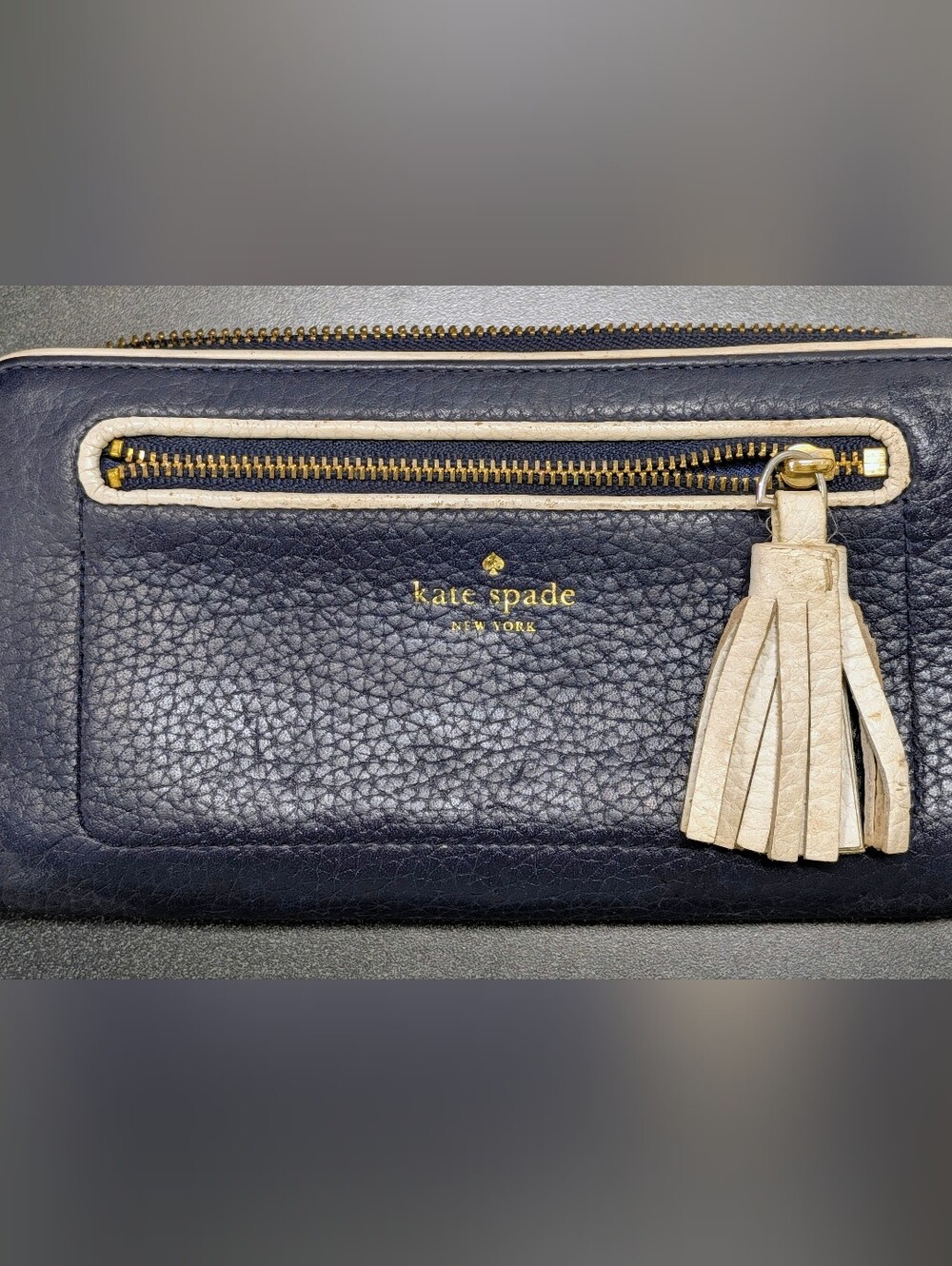 kate spade navy pebbled leather wallet with cream tassel charm